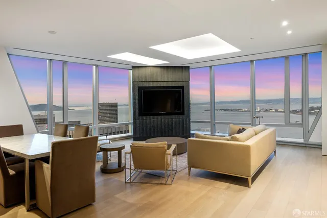 a living room with furniture a large window and a fireplace