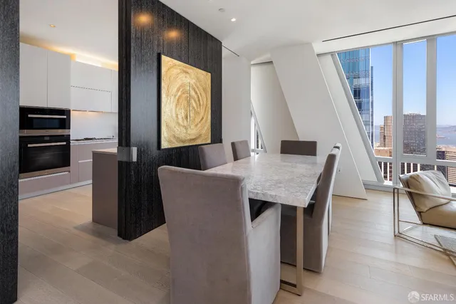 a dining room with furniture and a floor to ceiling window