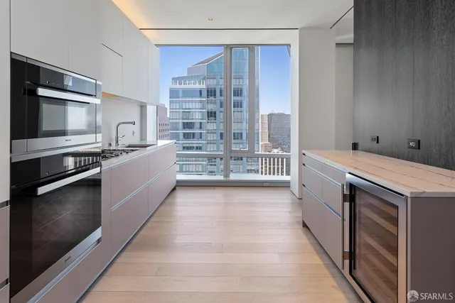 a kitchen with granite countertop a stove top oven and cabinets