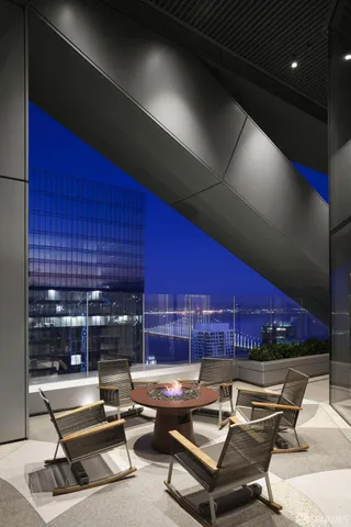 a building outdoor space with patio furniture and potted plants