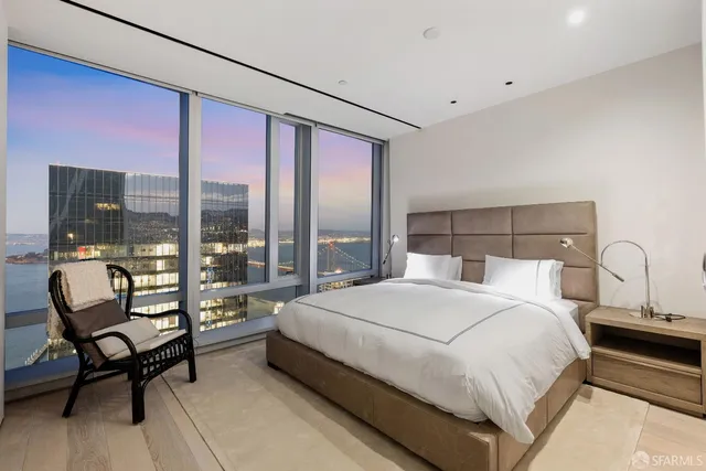 a bedroom with a large bed and a window