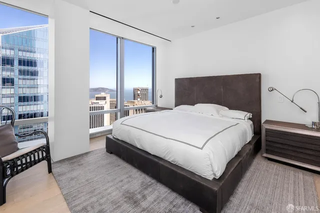 a large white bed in a white room