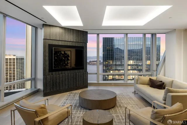 a living room with furniture and a floor to ceiling window