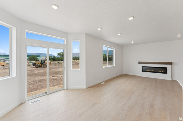 1004 West Paramount Cove South, Unit 315 Ogden, UT 84405 - Photo 9 of 42 Bright living area featuring wood-finish flooring and recessed lighting