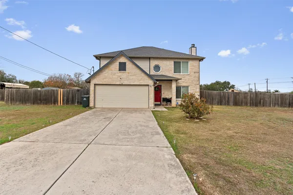 a front view of a house with a yard