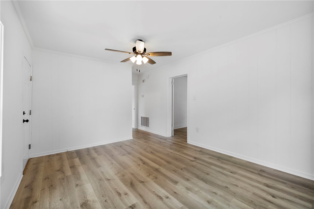 201 South 8th Street Easley, SC 29640 - Photo 16 of 28 Gleaming wood-look floors anchor this versatile room designed with classic vertical wall paneling.