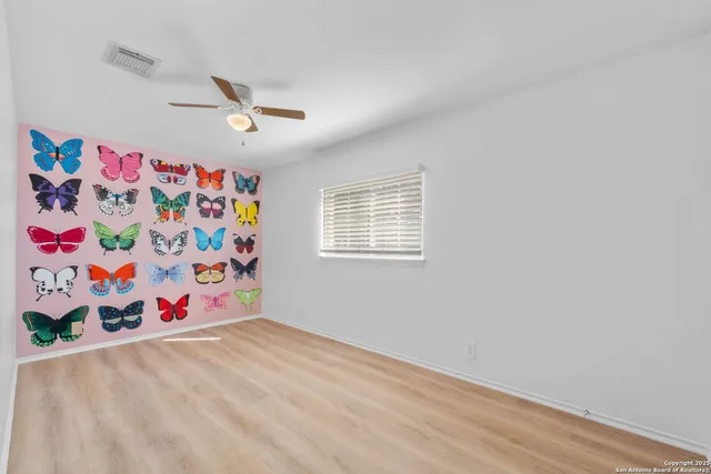 an empty room with toys and wooden floor