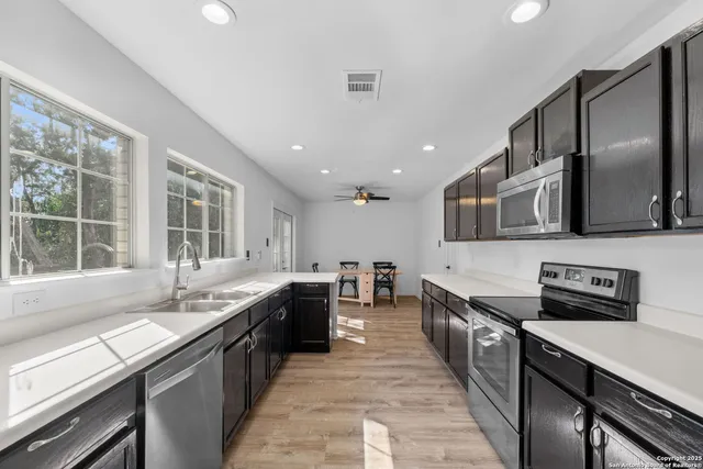 a kitchen with stainless steel appliances granite countertop counter space a sink and a stove