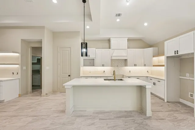 a view of kitchen with white cabinets