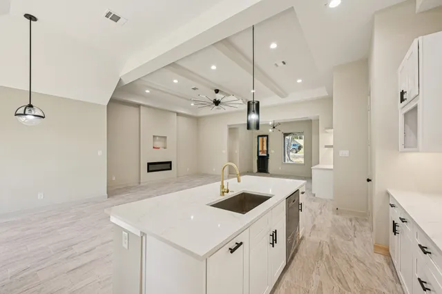 a kitchen with a sink a stove and refrigerator
