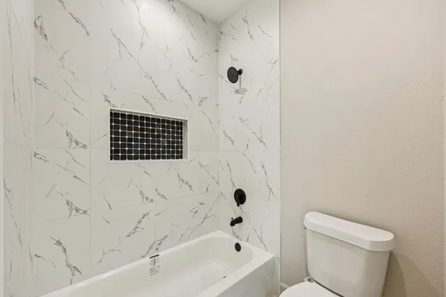 a bathroom with a shower and a toilet