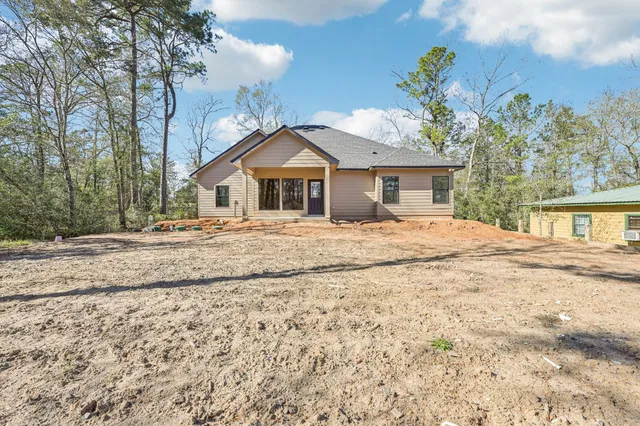 a view of a house with a yard covered in snow