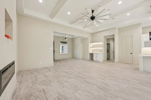 a view of a livingroom with a ceiling fan window and wooden floor