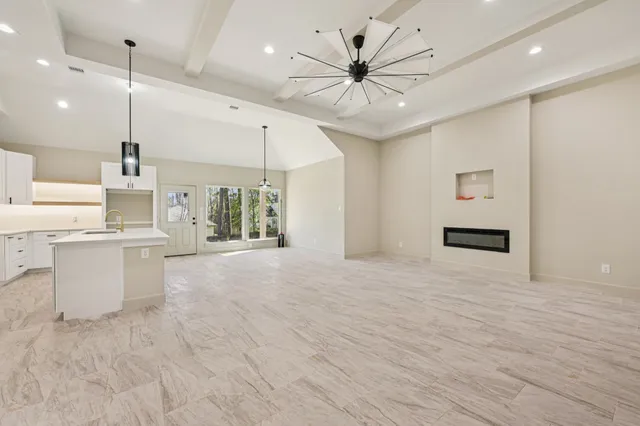 a large room with kitchen view and living room view