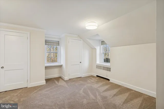 an empty room with windows and closet