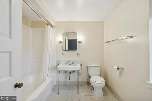 a bathroom with a toilet a sink and bathtub