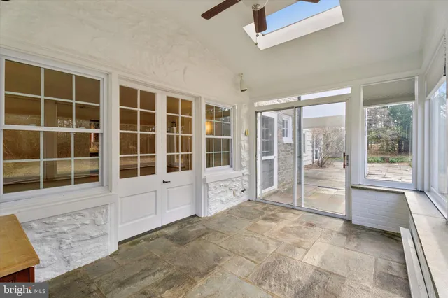 a view of an empty room with a window and balcony