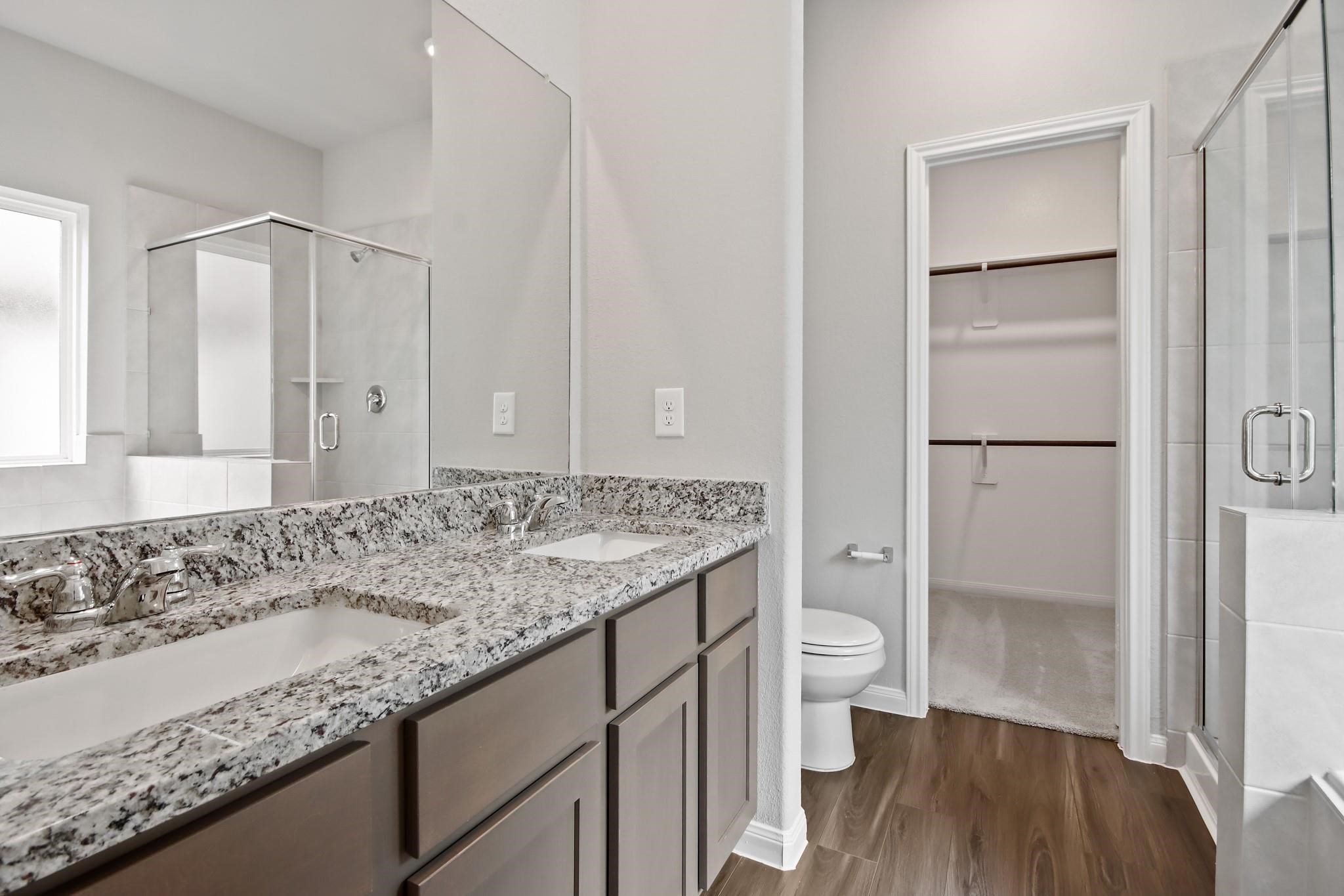 2416 Bluefish Court Conroe, TX 77384 - Photo 9 of 45 a bathroom with a granite countertop sink a toilet and shower