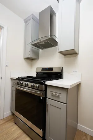 a stove top oven sitting inside of a kitchen
