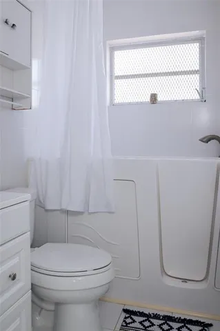 a bathroom with a toilet a sink and a shower