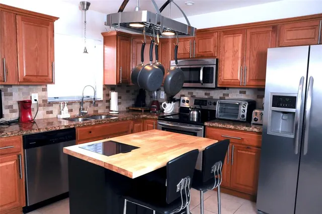 a kitchen with stainless steel appliances a sink counter space and cabinets