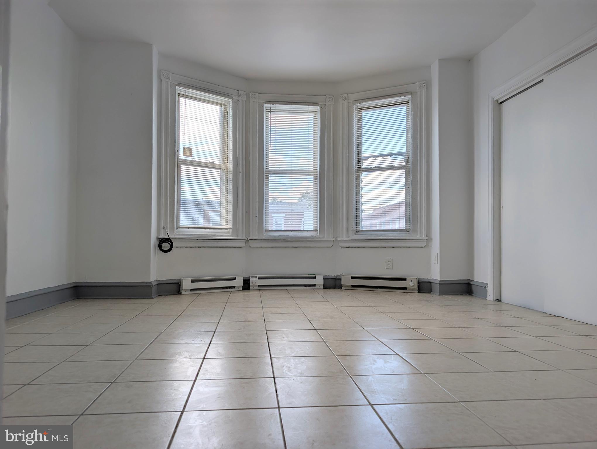 5205 North 5th Street, Unit 2F Philadelphia, PA 19120 - Photo 2 of 6 a view of an empty room with a window