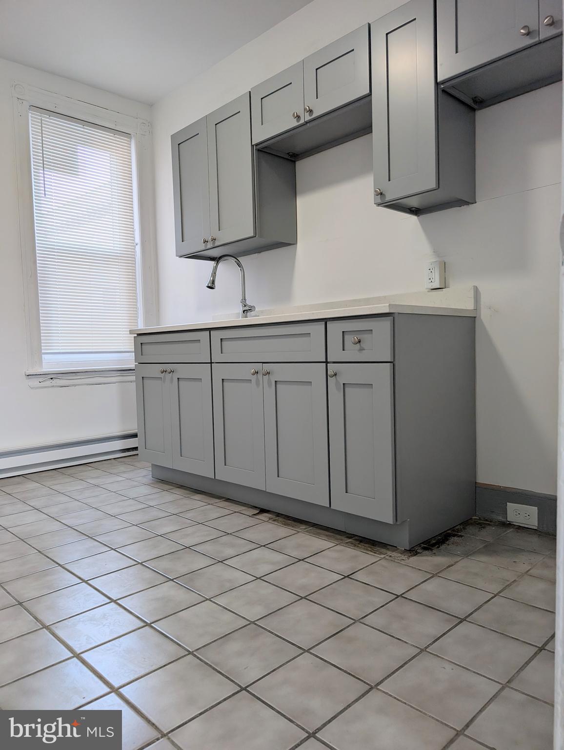 5205 North 5th Street, Unit 2F Philadelphia, PA 19120 - Photo 3 of 6 a kitchen with stainless steel appliances granite countertop a sink and a stove