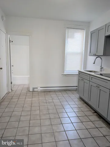 a view of a kitchen with white cabinets