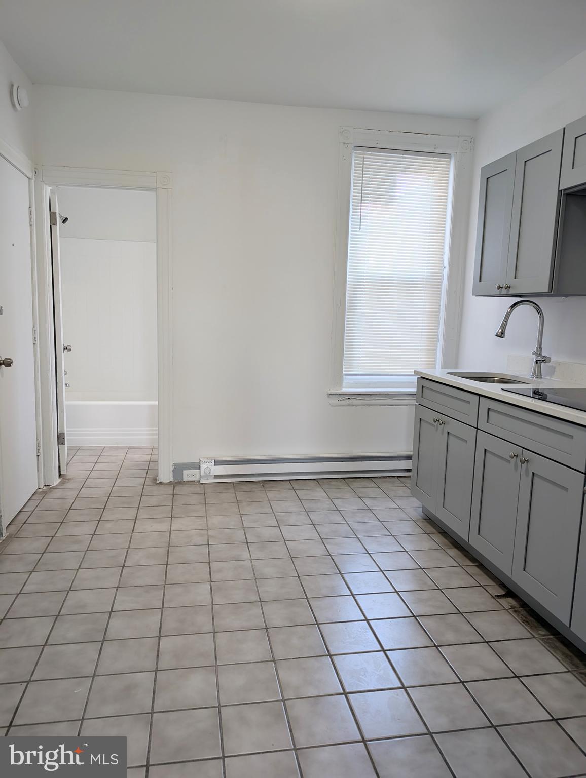 5205 North 5th Street, Unit 2F Philadelphia, PA 19120 - Photo 4 of 6 a view of a kitchen with white cabinets