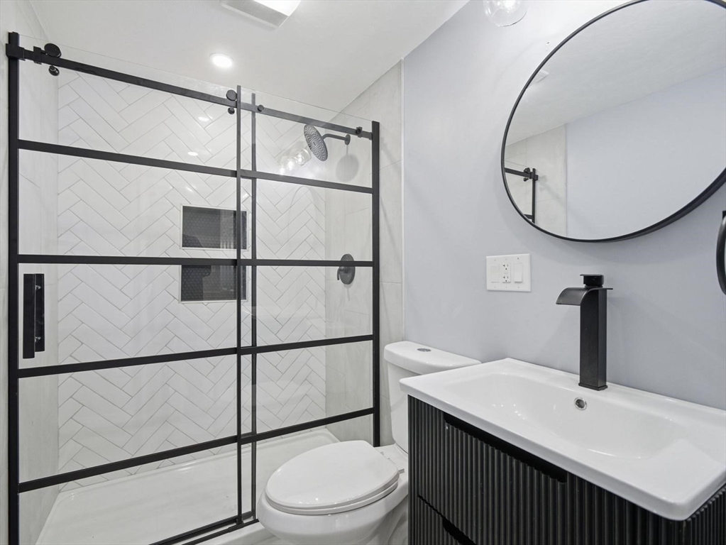 12 Howard Street Lynn, MA 01902 - Photo 13 of 26 a bathroom with a sink toilet and a mirror