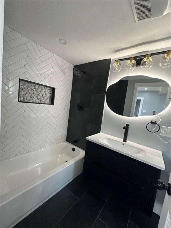 12 Howard Street Lynn, MA 01902 - Photo 15 of 26 a bathroom with a bathtub sink and mirror