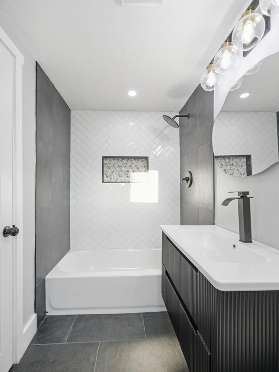 12 Howard Street Lynn, MA 01902 - Photo 16 of 26 a bathroom with a bathtub and a sink