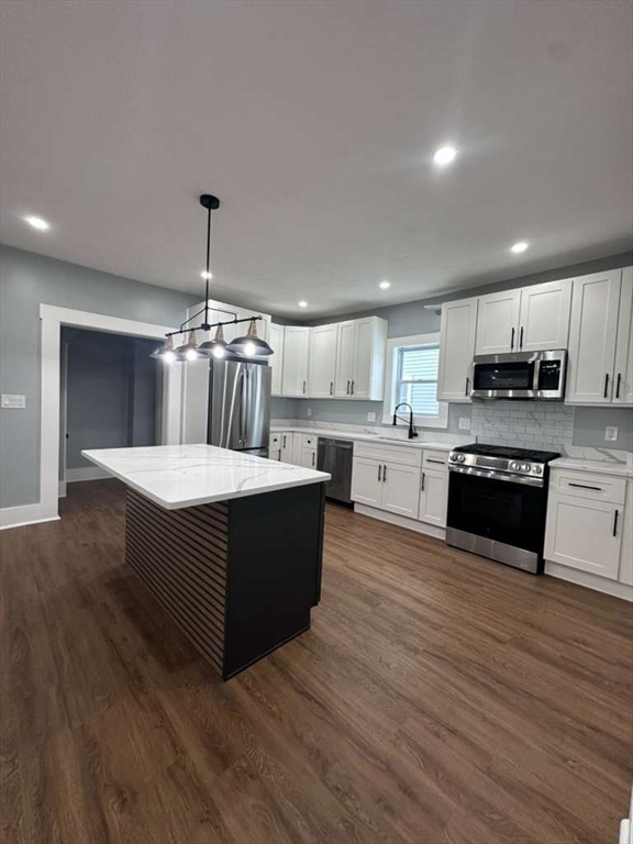 12 Howard Street Lynn, MA 01902 - Photo 2 of 26 a kitchen with stainless steel appliances kitchen island granite countertop a stove a sink and a refrigerator