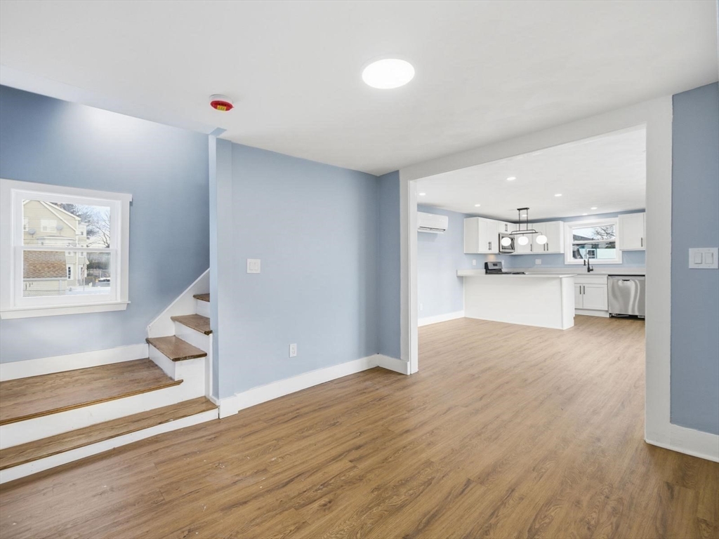12 Howard Street Lynn, MA 01902 - Photo 8 of 26 a view of a living room and kitchen with wooden floor