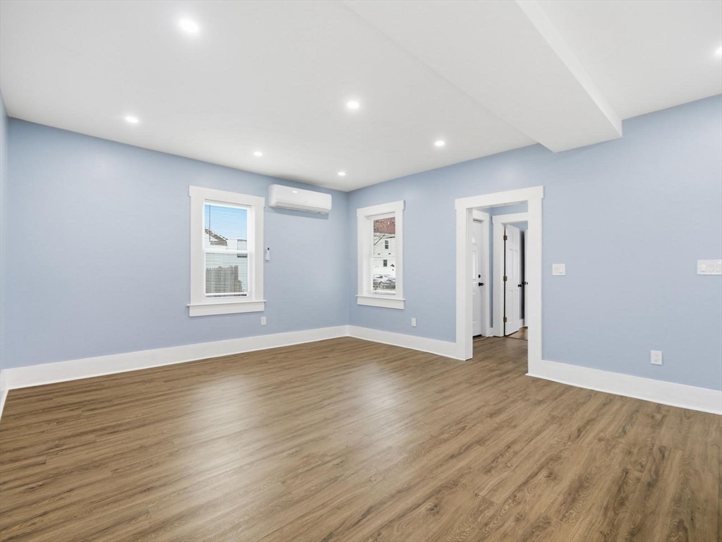 12 Howard Street Lynn, MA 01902 - Photo 10 of 26 a view of empty room with wooden floor and fan