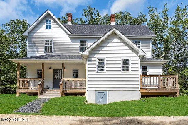 a view of house with yard and green space