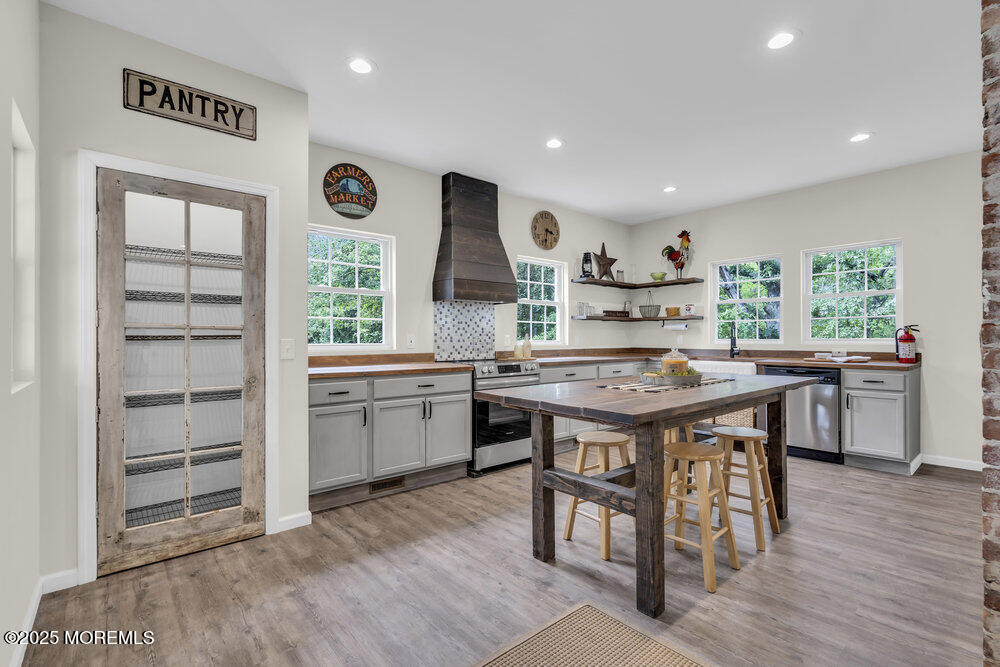 393 North County Line Road Jackson, NJ 08527 - Photo 12 of 21 a kitchen with granite countertop a stove a sink a dining table and chairs