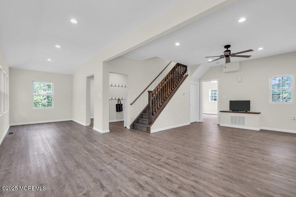 393 North County Line Road Jackson, NJ 08527 - Photo 14 of 21 an empty room with wooden floor ceiling fan and windows