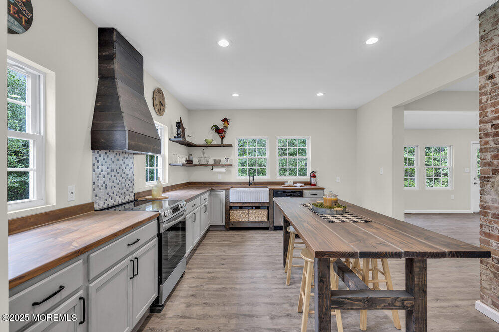 393 North County Line Road Jackson, NJ 08527 - Photo 16 of 21 a kitchen with a stove a sink dishwasher and a refrigerator with wooden floor