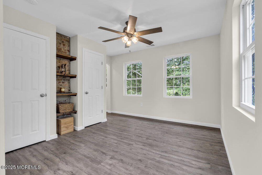 393 North County Line Road Jackson, NJ 08527 - Photo 17 of 21 wooden floor in an empty room with a window
