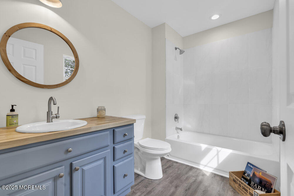 393 North County Line Road Jackson, NJ 08527 - Photo 21 of 21 a bathroom with a granite countertop toilet a sink and a mirror