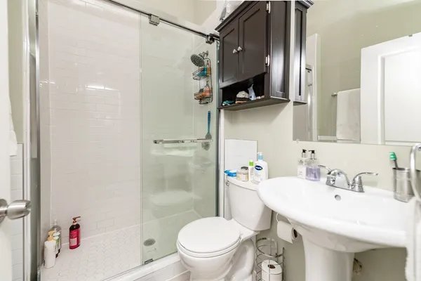 a bathroom with a sink toilet and shower