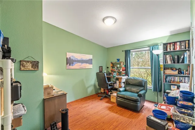 a living room with furniture and a bookshelf