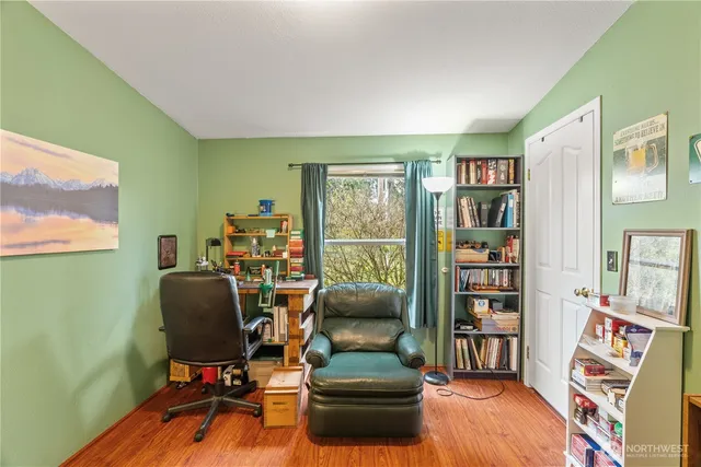 a livingroom with workspace and a window