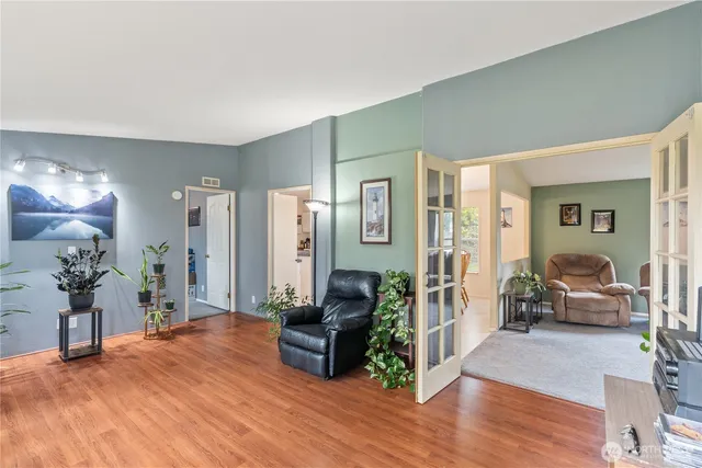a living room with furniture and wooden floor