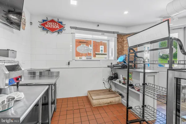 a kitchen with stainless steel appliances kitchen island granite countertop a sink and cabinets