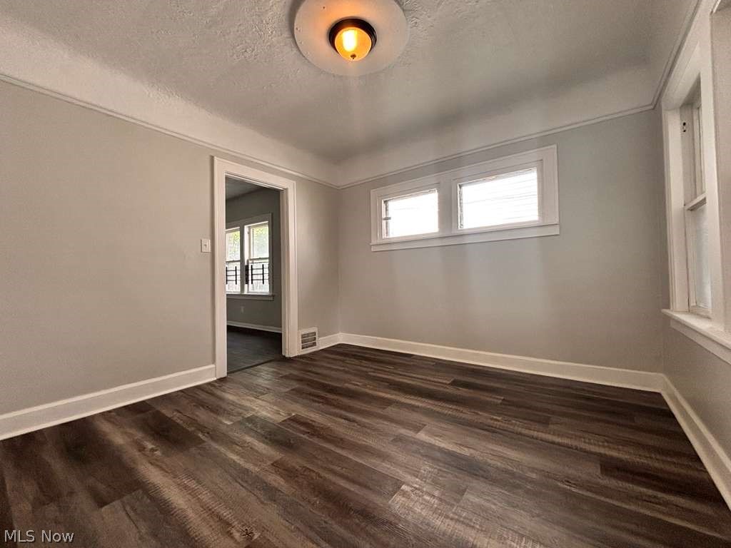 907 Rondel Road Cleveland, OH 44110 - Photo 4 of 26 Spacious room featuring wood-finish flooring, light gray walls, white trim, and a recessed ceiling light