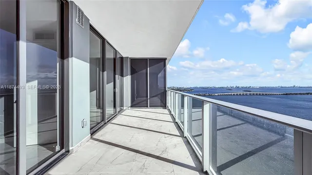 a kitchen with a stove a sink and white cabinets