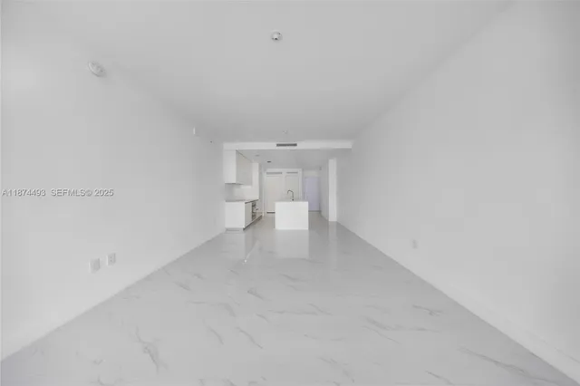 a view of a dining room with furniture one side kitchen view