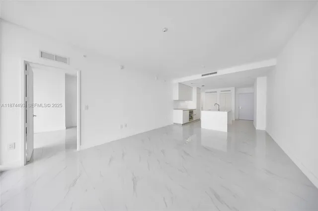 a room with lots of furniture and potted plants